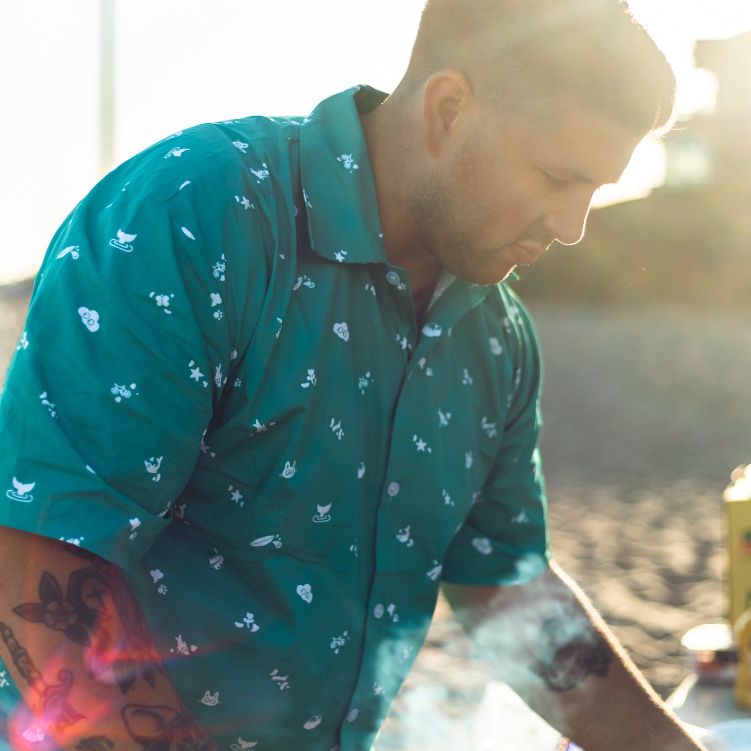 man at the beach wearing Cat & Cloud coffee Summer Button Down shirt