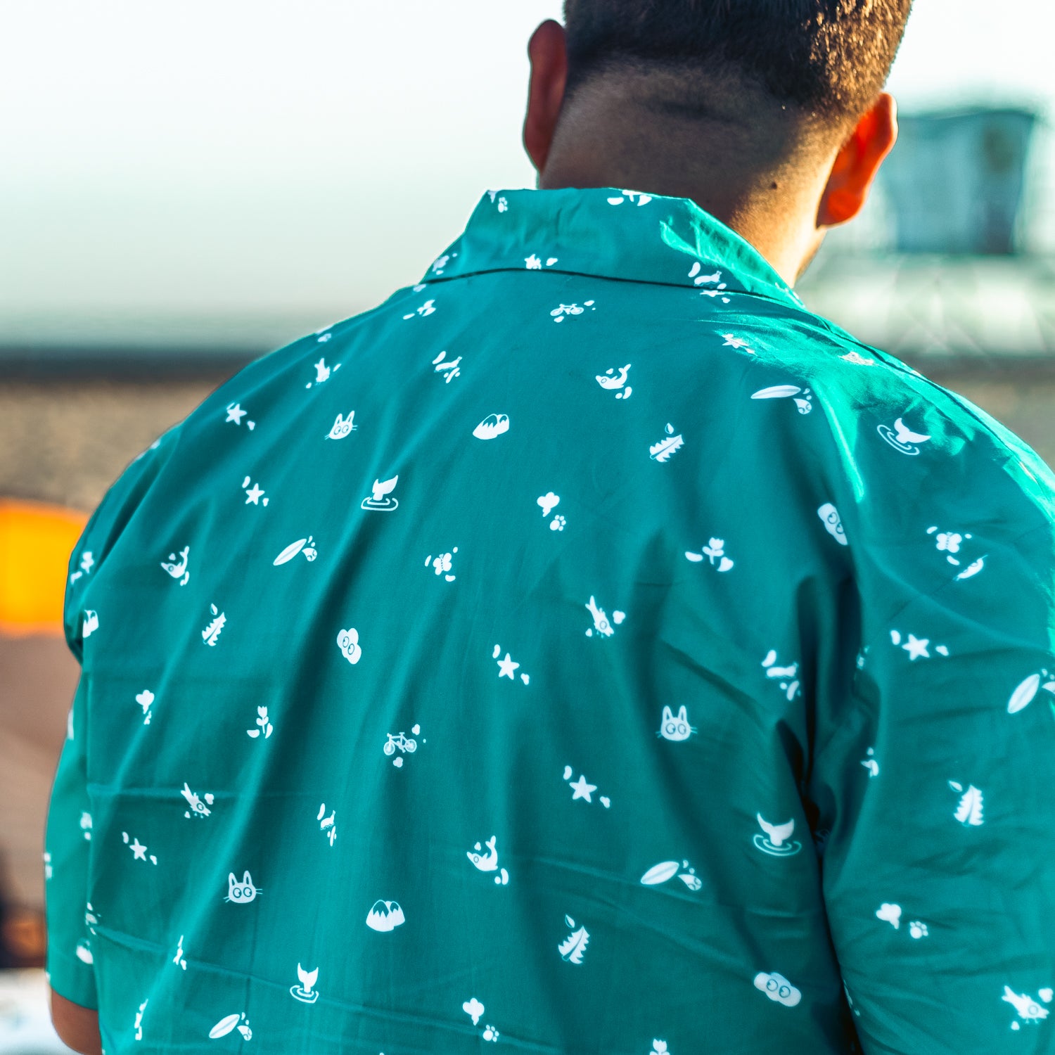 man at the beach wearing Cat & Cloud coffee Summer Button Down shirt 