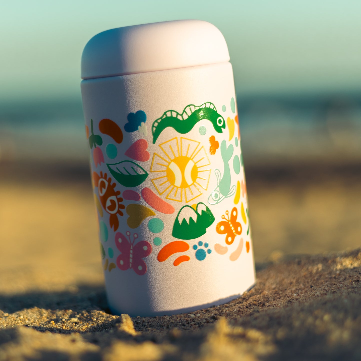 Close up shot of Cat & Cloud summer tumbler on the beach